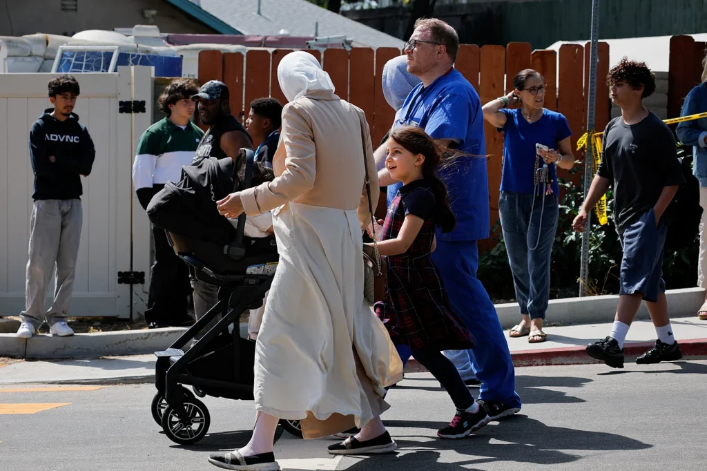 A child safely evacuates with family members after leaving the school located within the Islamic Center in San Diego, California, USA—the site of a gun attack. May 18, 2026. Photo: Reuters.